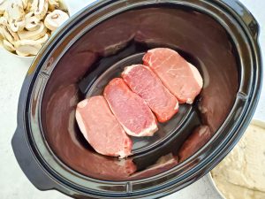 Add porkchops to slow cooker