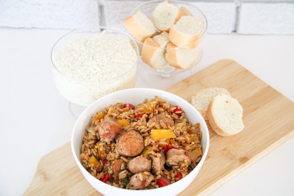 sausage and rice in a bowl with bread