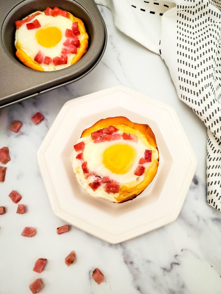 These easy Ham and Egg Biscuit Bowls are a delicious quick breakfast recipe. Also known as Breakfast Egg Muffins, they are made with only 3 ingredients and are a quick and easy breakfast. These egg cups with ham are perfect for brunch, breakfast, or any time you want a fast meal.